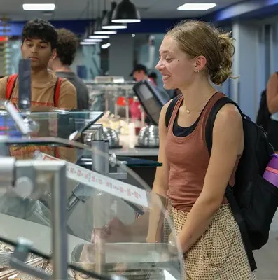 a student stands at a buffet in the dining hall